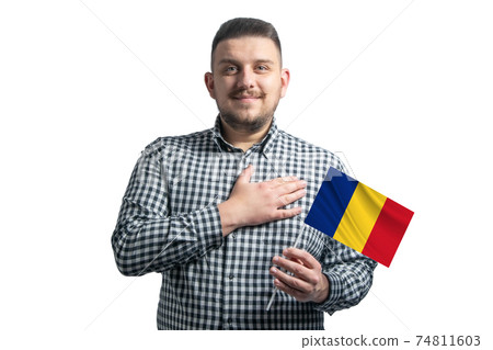 White guy holding a flag of Romania and holds his hand on his heart isolated on a white background With love to Romania White guy holding a flag of Romania and holds his hand on his heart isolated on a white background With love to Romania 74811603