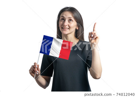 Happy young white woman holding flag of France and points thumbs up isolated on a white background 74812040