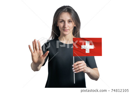 Happy young white woman holding flag of Switzerland and with a serious face shows a hand stop sign isolated on a white background Happy young white woman holding flag of Switzerland and with a serious face shows a hand stop sign isolated on a white background 74812105