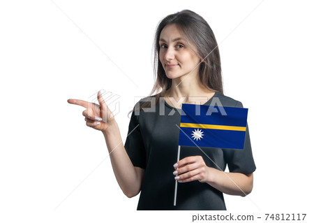 Happy young white woman holding flag Nauru and points to the left isolated on a white background 74812117