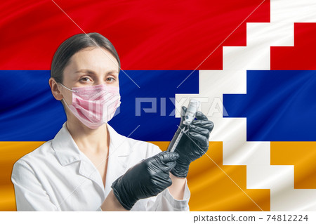 Girl doctor prepares vaccination against the background of the Nagorno-Karabakh Republic flag. Vaccination concept Nagorno-Karabakh Republic Girl doctor prepares vaccination against the background of the Nagorno-Karabakh Republic flag. Vaccination concept Nagorno-Karabakh Republic 74812224