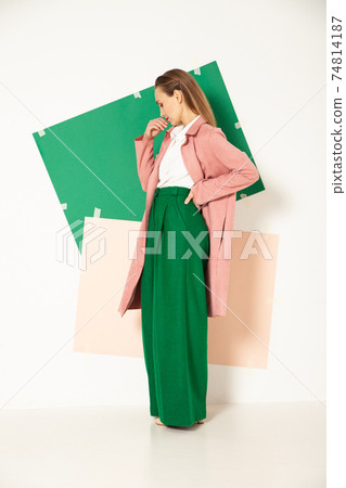 Elegant woman in stylish colorful wear in studio with white background Elegant woman in stylish colorful wear in studio with white background 74814187