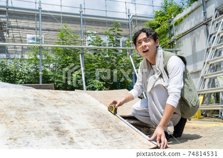 Young carpenter man working at a construction site Young carpenter man working at a construction site 74814531