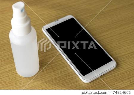 Image of alcohol disinfecting smartphone 74814665