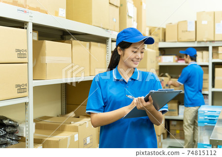 Young woman working in a warehouse 74815112