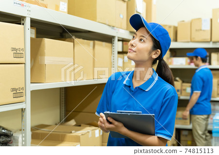 Young woman working in a warehouse 74815113