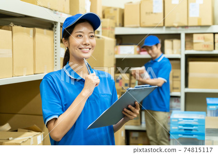 Young woman working in a warehouse 74815117