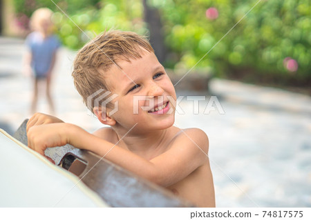 Side portrait mischievous boy, freckled nose, open mouth intriguing cunning mood, smile laugh face expression gestures. Joys Happy Childhood relationship behaviour education parenthood. Funny photo 74817575