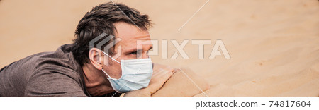 BANNER Close-up side portrait man wear mask, face expression emotion, lies on stomach arms crossed under head. COVID stress syndrome, mental health, fear of danger contamination, social consequence BANNER Close-up side portrait man wear mask, face expression emotion, lies on stomach arms crossed under head. COVID stress syndrome, mental health, fear of danger contamination, social consequence 74817604