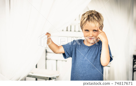 Portrait sly smile narrowed eyes freckled boy points finger to head have idea, facial expression hand gesture. Funny mischievous mood. Happy childhood, behaviour education psychology relationship Portrait sly smile narrowed eyes freckled boy points finger to head have idea, facial expression hand gesture. Funny mischievous mood. Happy childhood, behaviour education psychology relationship 74817671