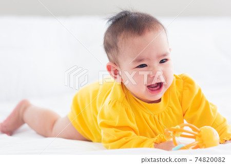 newborn little baby prone on the bed at home newborn little baby prone on the bed at home 74820082