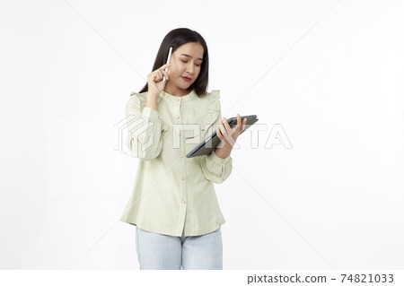 Beautiful young woman holding digital tablet and looking at camera with smile while standing. Wireless technology. Beautiful young woman holding digital tablet and looking at camera with smile while standing. Wireless technology. 74821033