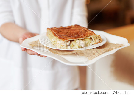 Chicken and potato pie on the dining table. The food is ready to eat. Puff pastry. kitchen utensils for cooking 74821163