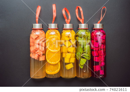 Cambucha with various fruits arranged in the form of a rainbow. Homemade fermented raw kombucha tea with different flavorings. Healthy natural probiotic flavored drink. LGBT 74821611