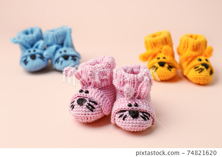 Pregnancy motherhood perenthood concept, Three pairs of baby booties funny bunny rabbit design on pink background, baby shower, first birthday party banner, daycare, kindergarten, day nursery Pregnancy motherhood perenthood concept, Three pairs of baby booties funny bunny rabbit design on pink background, baby shower, first birthday party banner, daycare, kindergarten, day nursery 74821620