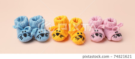 Pregnancy motherhood perenthood concept, Three pairs of baby booties funny bunny rabbit design on pink background, baby shower, first birthday party banner, daycare, kindergarten, day nursery Pregnancy motherhood perenthood concept, Three pairs of baby booties funny bunny rabbit design on pink background, baby shower, first birthday party banner, daycare, kindergarten, day nursery 74821621