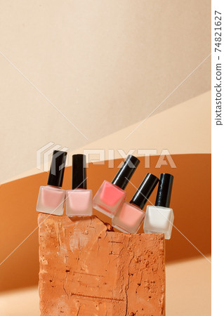 Set of nail polish in neautral colors on Minimal modern brick stone product display on beige background with podium, trendy presentation of cosmetology products, beauty industry, copy space Set of nail polish in neautral colors on Minimal modern brick stone product display on beige background with podium, trendy presentation of cosmetology products, beauty industry, copy space 74821627