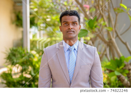 Portrait of handsome young African businessman wearing suit Portrait of handsome young African businessman wearing suit 74822246