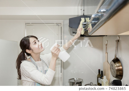 Woman cleaning the ventilation fan (with real dirt) 74823865