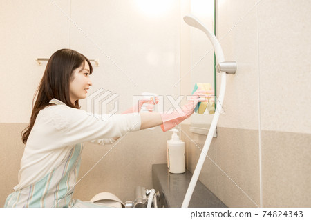 Woman cleaning the bath Woman cleaning the bath 74824343