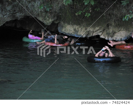 A limestone cave on a trekking tour in Vang Vieng, Laos. A limestone cave on a trekking tour in Vang Vieng, Laos. 74824424