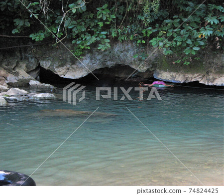 A limestone cave on a trekking tour in Vang Vieng, Laos. A limestone cave on a trekking tour in Vang Vieng, Laos. 74824425
