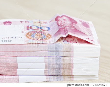 close-up of a stack of 100-yuan chinese banknotes, concept for favorable currency movement. close-up of a stack of 100-yuan chinese banknotes, concept for favorable currency movement. 74824872