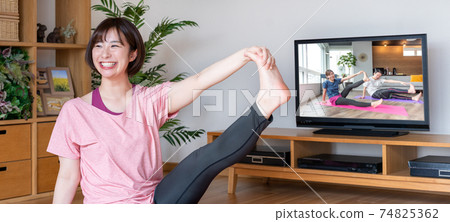 Online yoga banner size for young women stretching in the living room 74825362