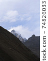 Mountain against blue sky in winter with clouds 74826033