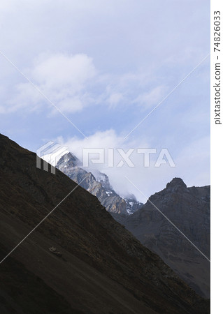 Mountain against blue sky in winter with clouds 74826033