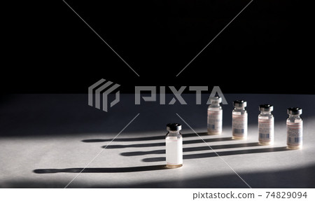 Vaccines Used for prevention, immunity and treatment from covid-19 infection or coronavirus. Concepts of disease prevention. Black isolated background Vaccines Used for prevention, immunity and treatment from covid-19 infection or coronavirus. Concepts of disease prevention. Black isolated background 74829094