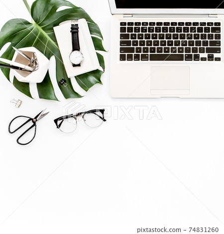 Home office workspace mockup with laptop, tropical leaves Monstera, clipboard, notebook and accessories on white background. Flat lay, top view Home office workspace mockup with laptop, tropical leaves Monstera, clipboard, notebook and accessories on white background. Flat lay, top view 74831260
