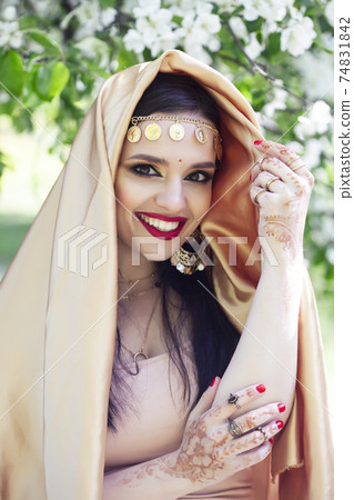 young pretty indian girl in jewelry and veil posing cheerful happy smiling in green park, lifestyle people concept young pretty indian girl in jewelry and veil posing cheerful happy smiling in green park, lifestyle people concept 74831842