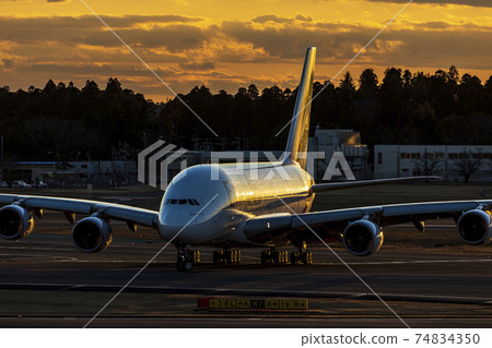 Aircraft landing at dusk Aircraft landing at dusk 74834350