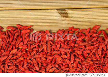 Goji berries on light wooden surface Goji berries on light wooden surface 74835451
