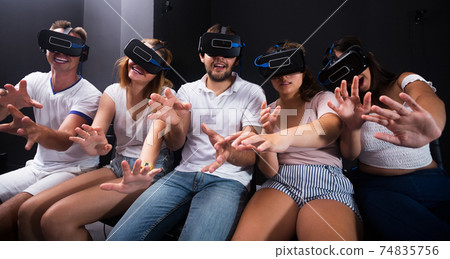 People wearing virtual reality goggles People wearing virtual reality goggles 74835756