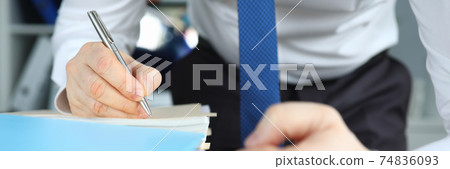 Man in business suit and tie number stack of documents. 74836093