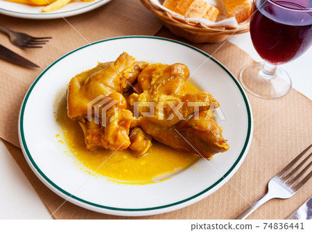 Appetizing fried pig legs with potatoes served on plate Appetizing fried pig legs with potatoes served on plate 74836441