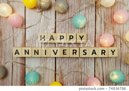 Happy Anniversary alphabet letter with LED cotton balls on wooden background 74836786