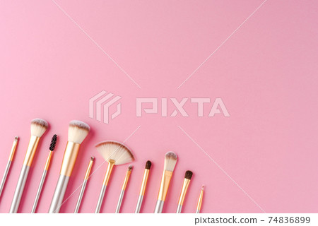 Collection of golden makeup brushes with copyspace Collection of golden makeup brushes with copyspace 74836899
