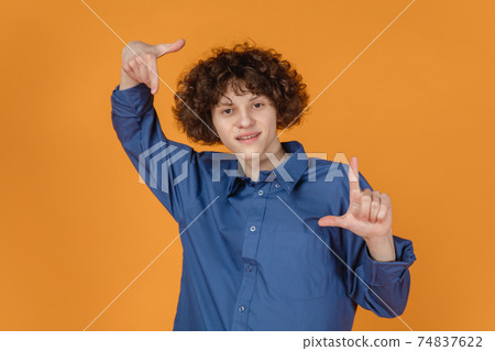 Caucasian young man's portrait isolated on yellow studio background with copyspace Caucasian young man's portrait isolated on yellow studio background with copyspace 74837622