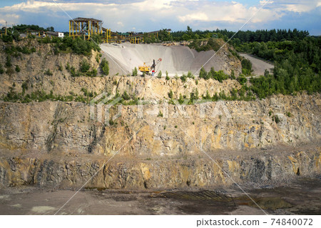 a yellow faucet stands near a mountain from a macadam on a background 74840072