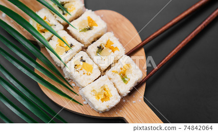 Dessert sushi. Sweet kiwi, pineapple and banana sushi rolls 74842064