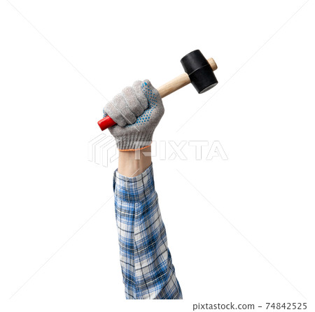 hand holds a construction tool hammer 74842525