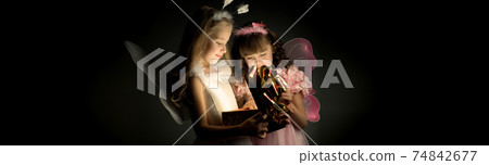 two little girl open the gift box 74842677