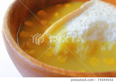 Bread soaked in corn soup with grains Dip bread corn potage Bread soaked in corn soup with grains Dip bread corn potage 74844058