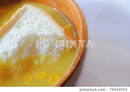 Bread soaked in corn soup with grains Dip bread corn potage Bread soaked in corn soup with grains Dip bread corn potage 74844059