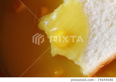 Bread soaked in corn soup with grains Dip bread corn potage Bread soaked in corn soup with grains Dip bread corn potage 74844086