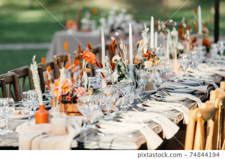 Luxury wedding reception, dining table setup with decoration on rustic wooden table 74844194
