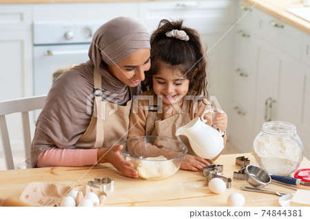 Young Muslim Mom Baking Together With Her Little Daughter In Kitchen Young Muslim Mom Baking Together With Her Little Daughter In Kitchen 74844381